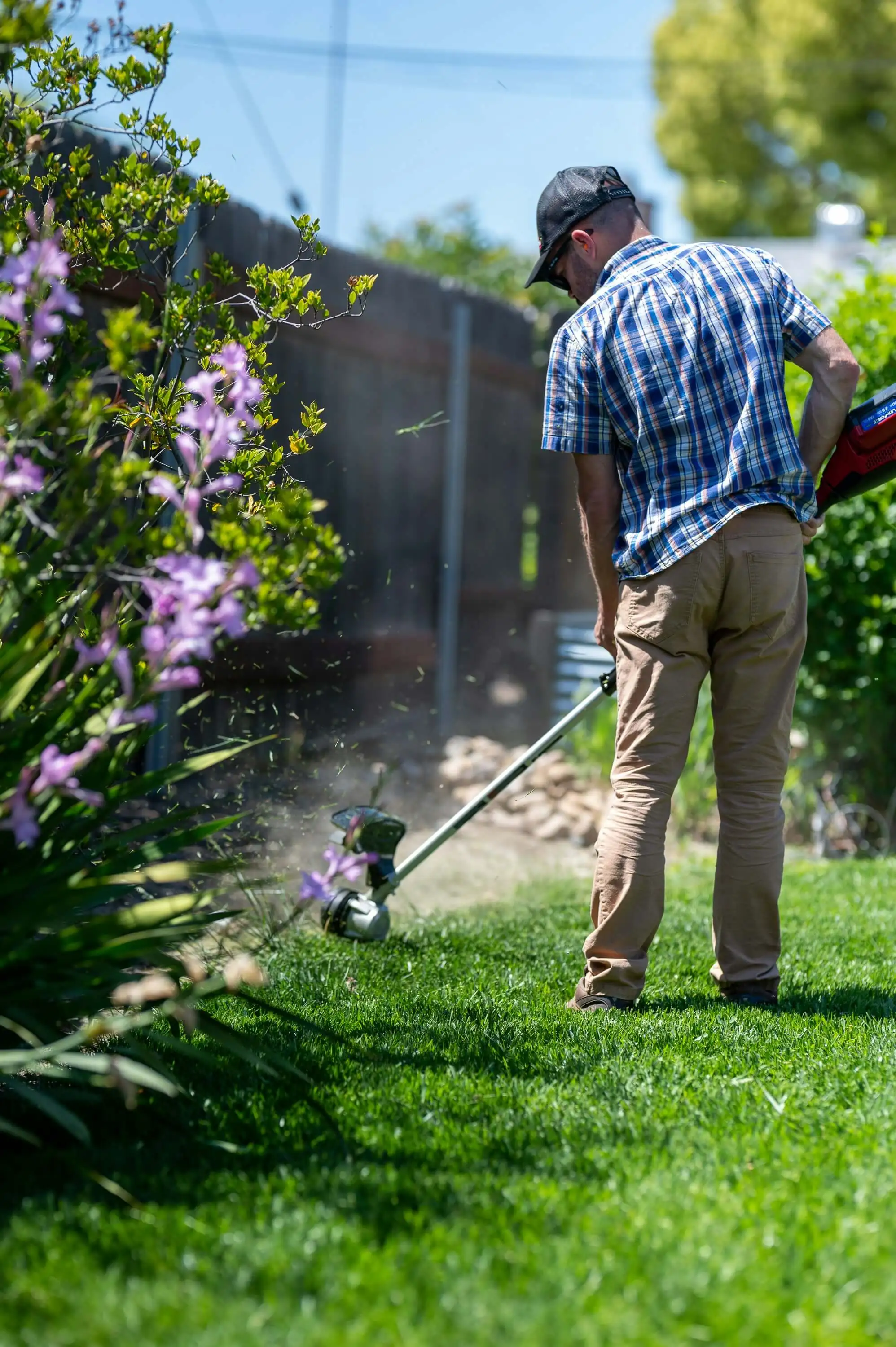 Gardener cutting a large lawn with a professional mower.